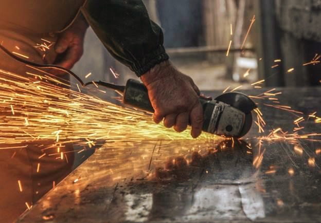 man holding grinding wheel.jpeg