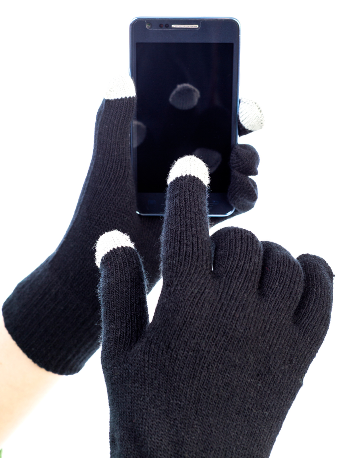 Black gloves with touchscreen fingertips touching a smartphone.