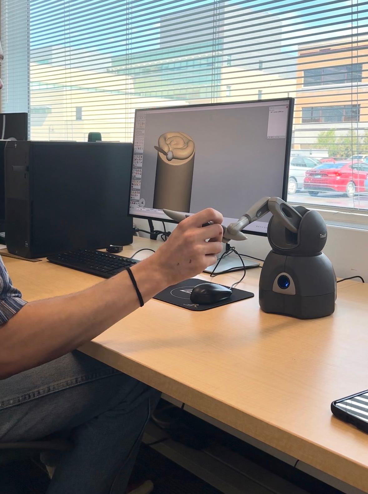 Sam Young using haptic pen in Innovation Hub.