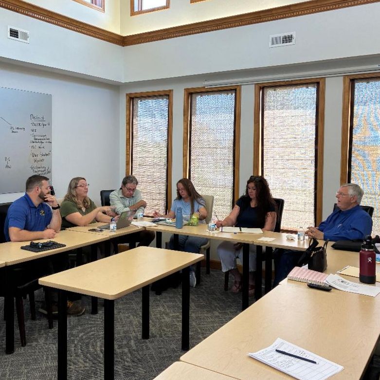 "Members of the housing workgroup meeting around a table during the year-one workgroup gathering"