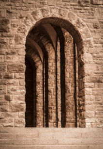 Old stone archway with keystone block in center.