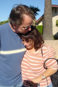 Volunteer Hans comforts a woman who cried upon receiving gifts from Santa for her kids.