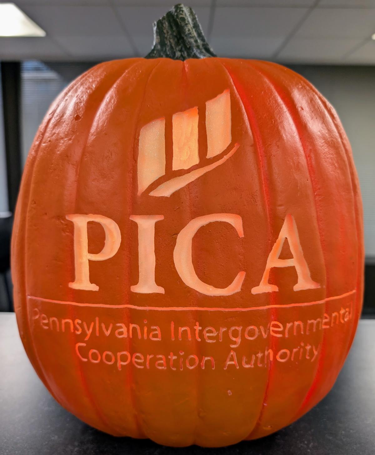 Pumpkin with the PICA logo carved into it
