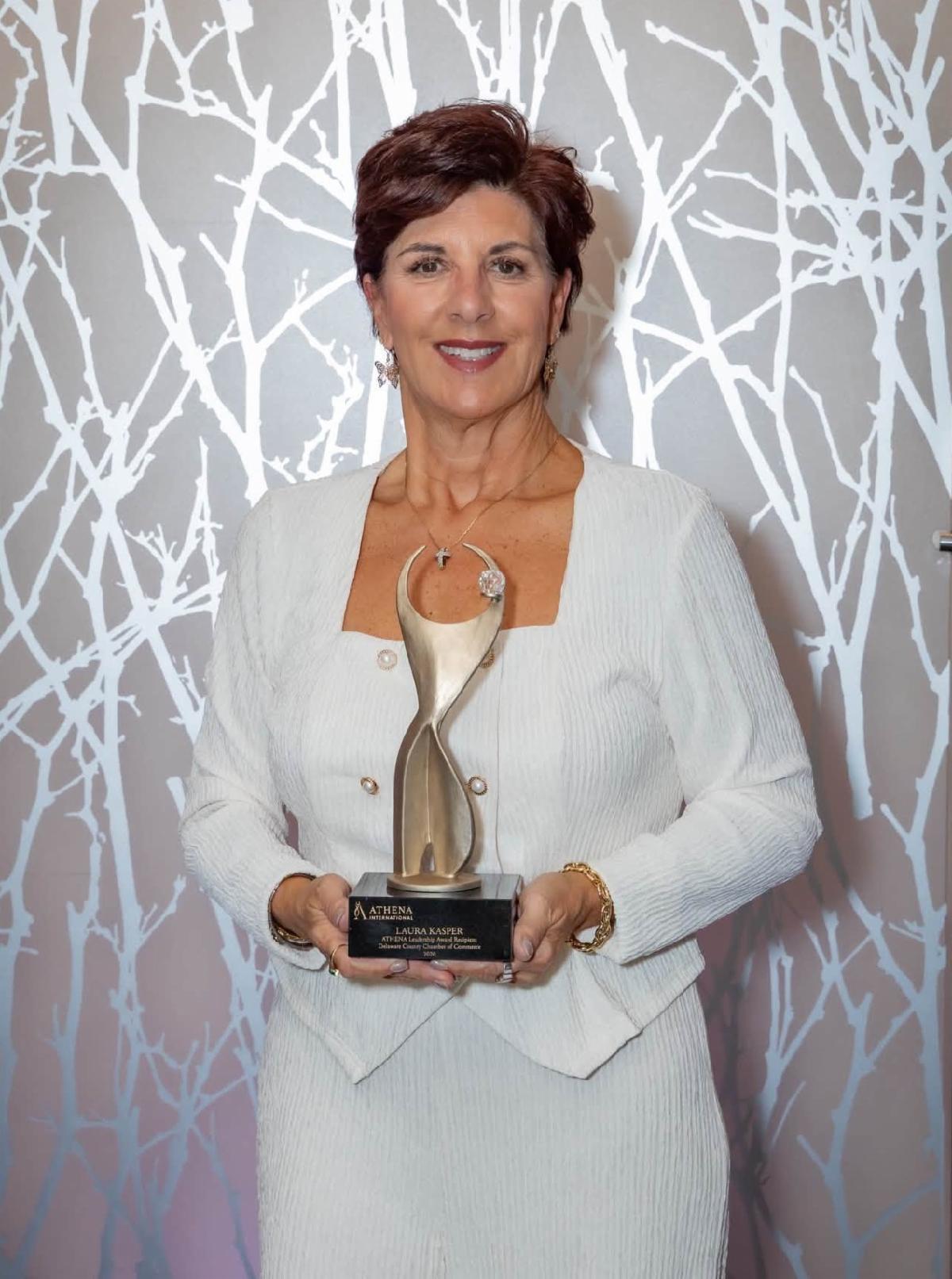 Headshot of Laura Kasper holding her Athena Award