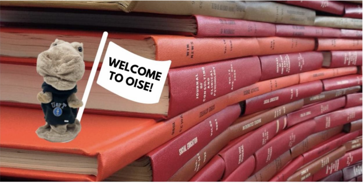 Books and Welcome to OISE sign