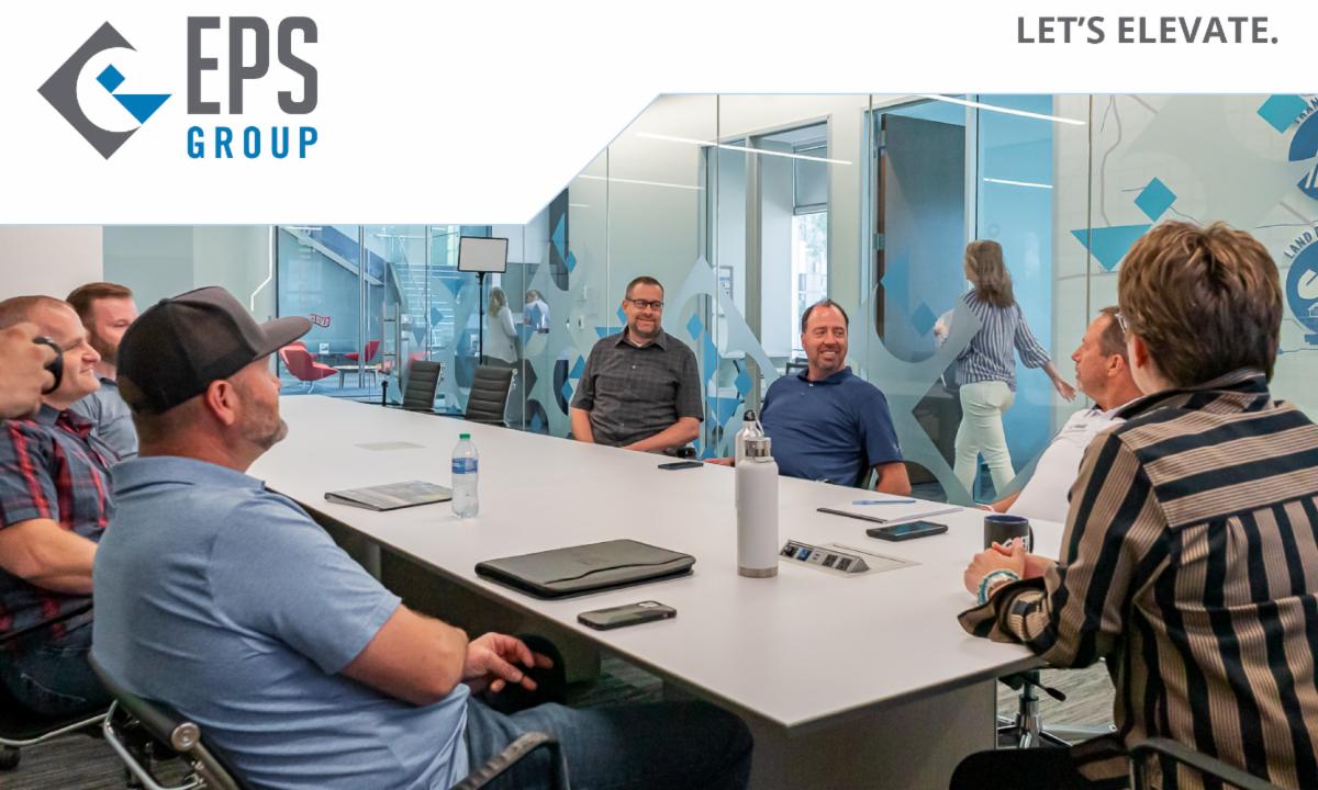 EPS logo and Let's Elevate tagline above a photo of CEO Kathey Wagner conducting a board meeting.