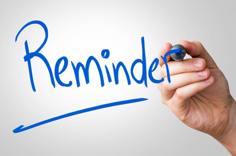 Reminder hand writing with a blue mark on a transparent board