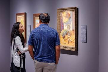 Man and woman looking at a painting