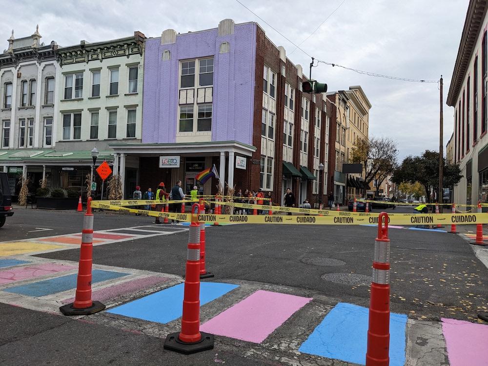 Image of the crosswalk taped off on Wall Street with vibrant new paint colors.
