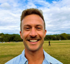 Head shot of Drew Miller, NYCPS health education teacher, smiling at the camera.