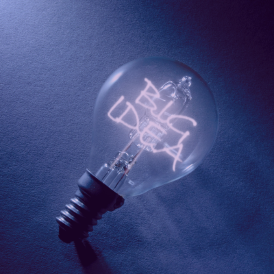 Light bulb with neon words 'Big Idea' inside of it