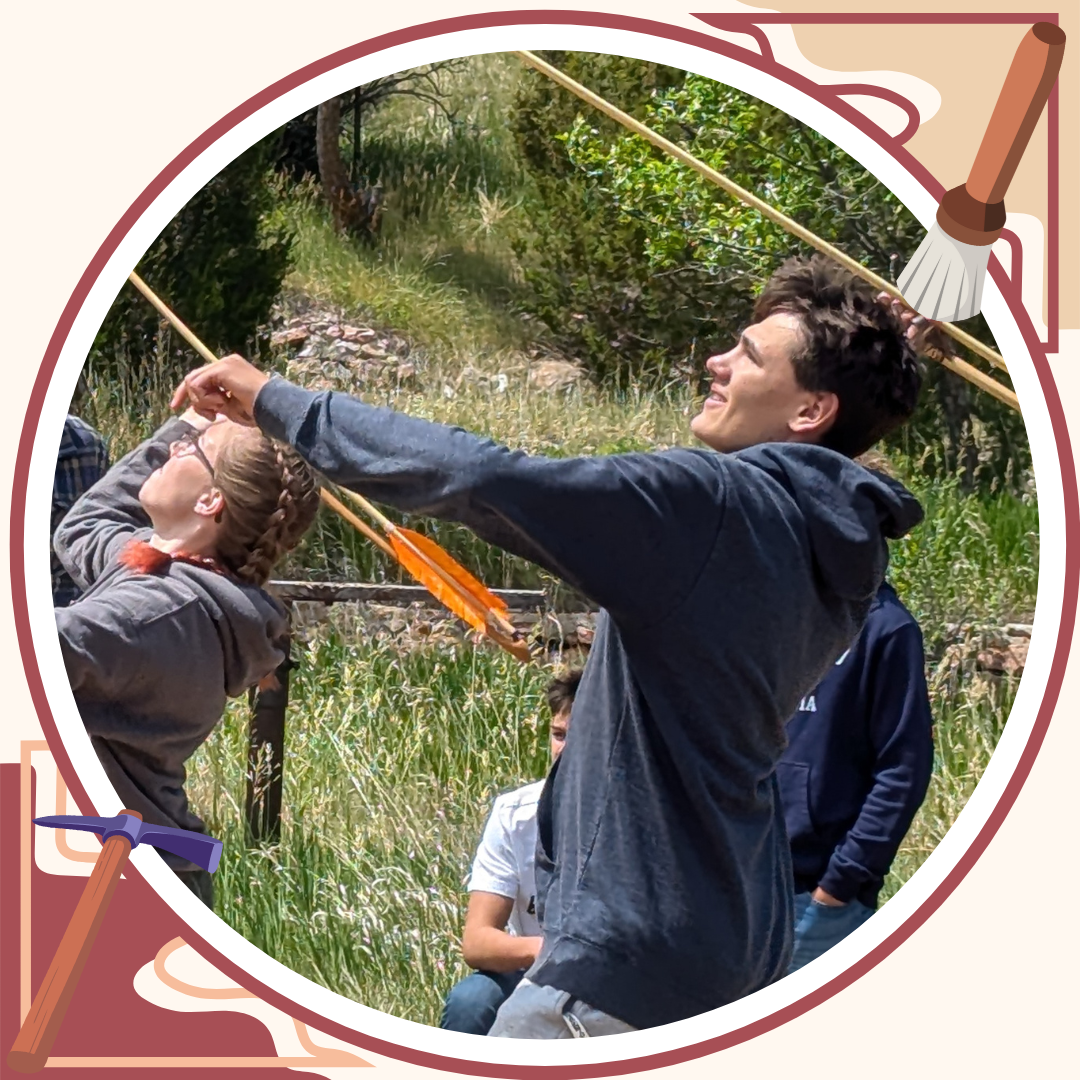Photo of students throwing ancient spear arrows. 