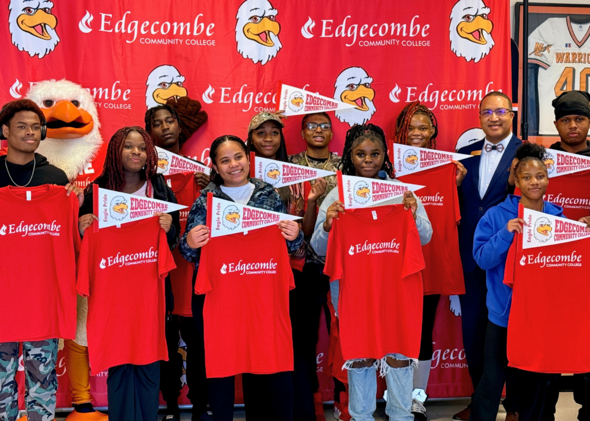 Group of students holding pennant flags and red tshirts