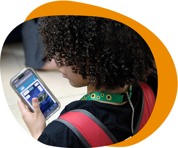 Young person looking at their cell phone