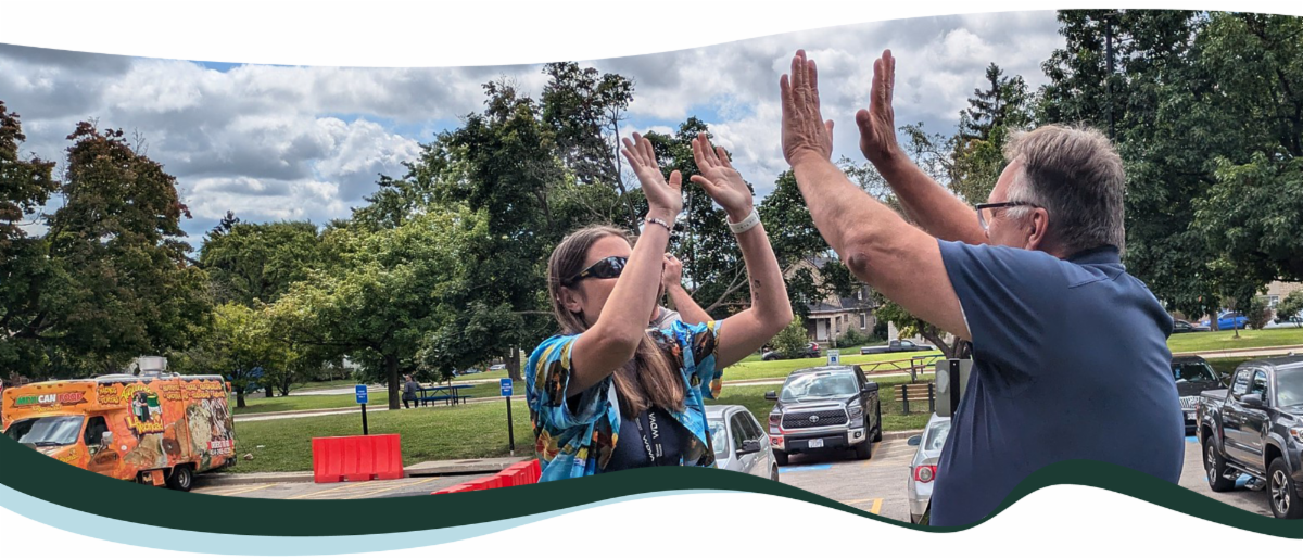 Two people high-fiving at an event