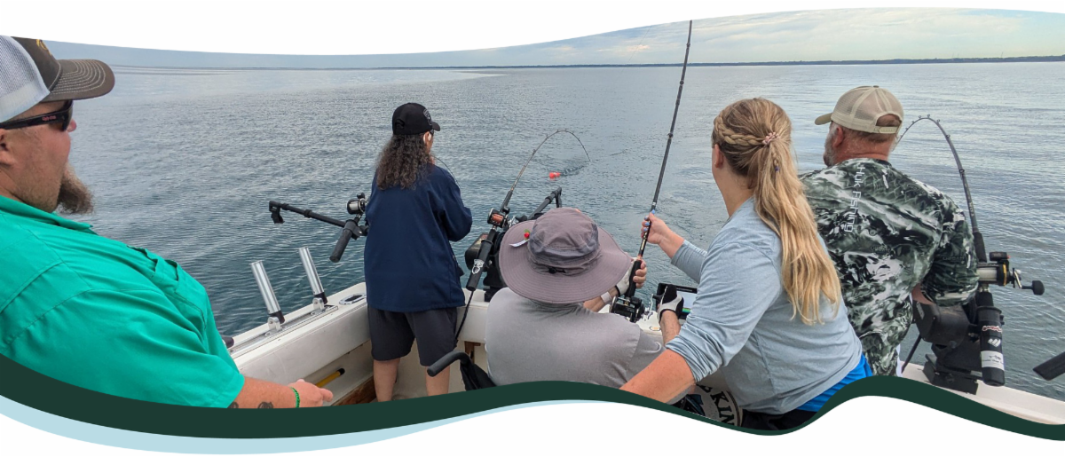 Five people fishing on a boat