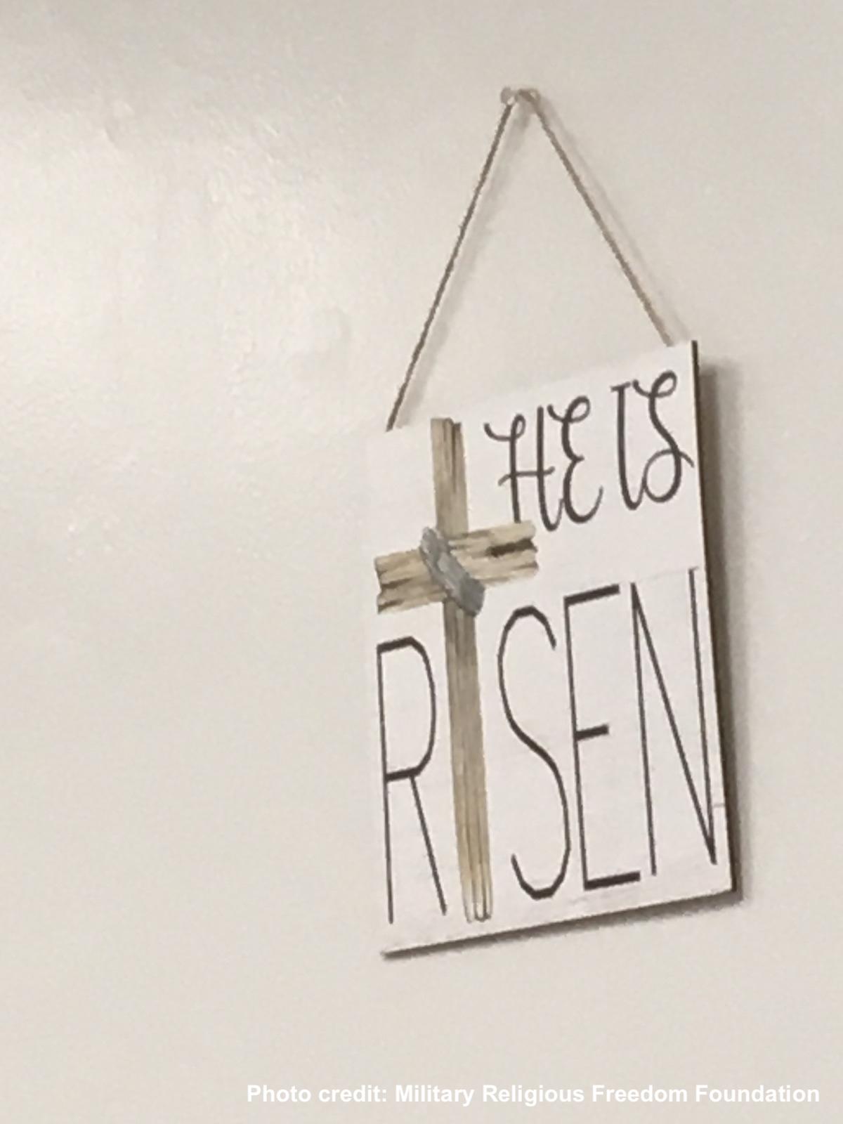 Close up of he is risen sign on seating area wall