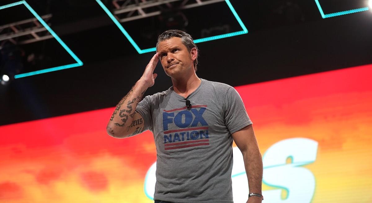 Pete Hegseth on stage wearing Fox News t-shirt
