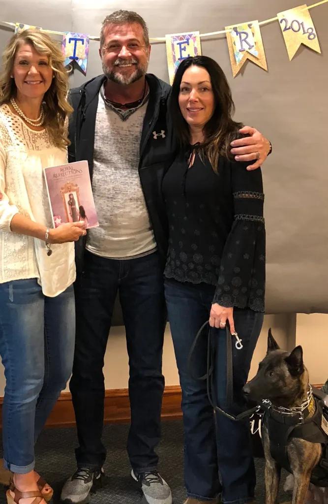 Sherry Eifler holding up her book with Victor and Eileen Marx