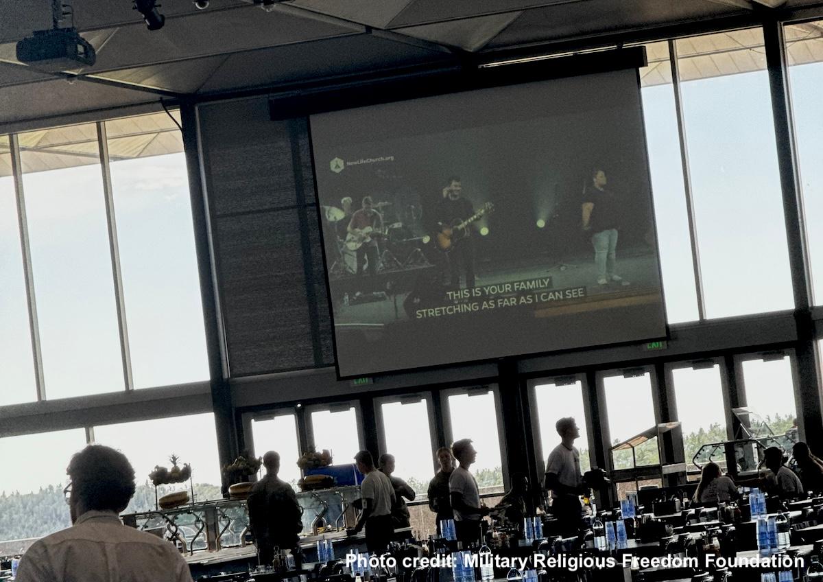 New Life Church worship service playing on huge TV screen in Air Force Academy dining hall