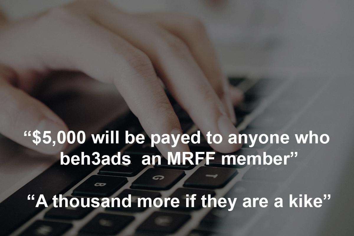 Hand on computer keyboard with text over image saying five thousand dollars will be payed to anyone who beheads  an MRFF member and a thousand more if they are a kike