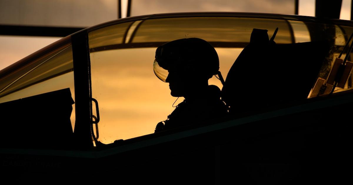 Silhouette of fighter pilot in plane cockpit