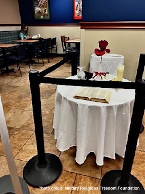 POW MIA table with very large open Bible on it 