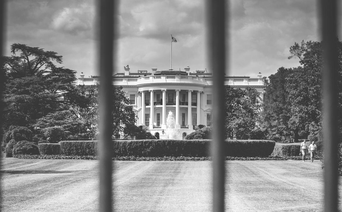 View of the White House through the bars of the fence