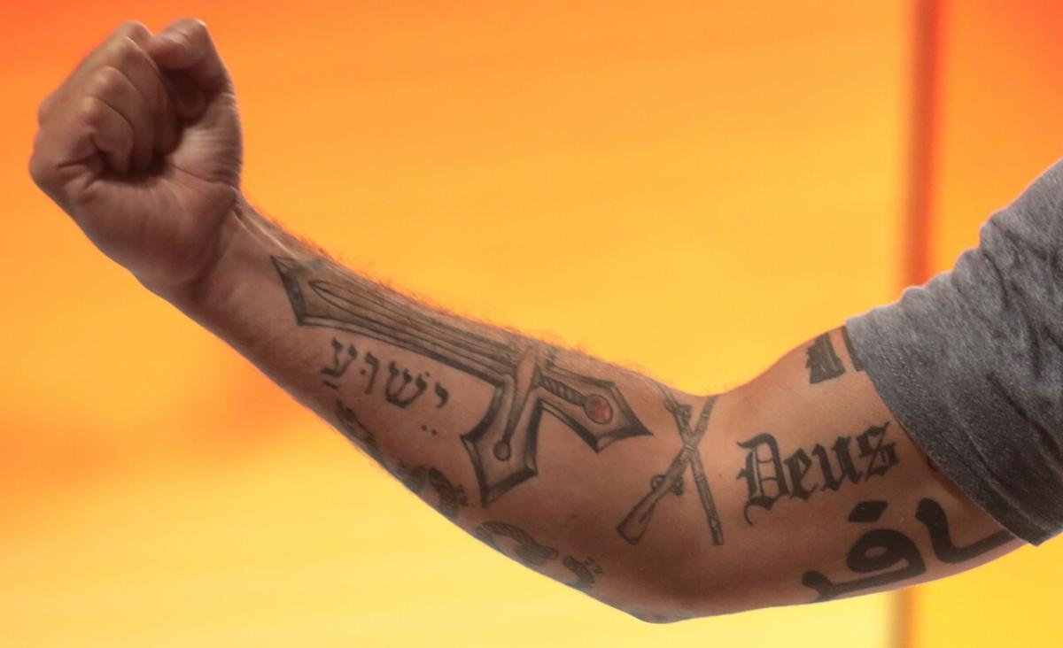 Pete Hegseth's arm covered in Christian and crusader tattoos