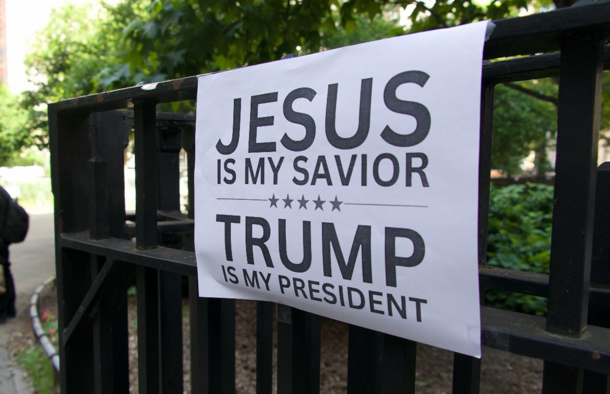Sign on fence that says Jesus is my savior Trump is my president