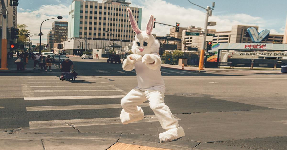 Person in Easter bunny costume doing a karate move in the middle of a city street