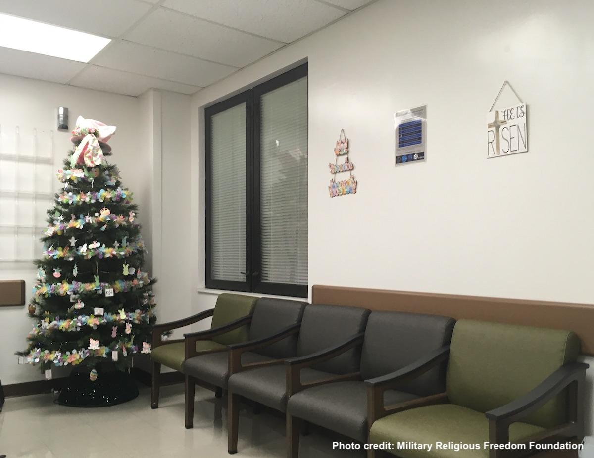 Wide photo showing easter tree in corner and he is risen sign on adjacent wall