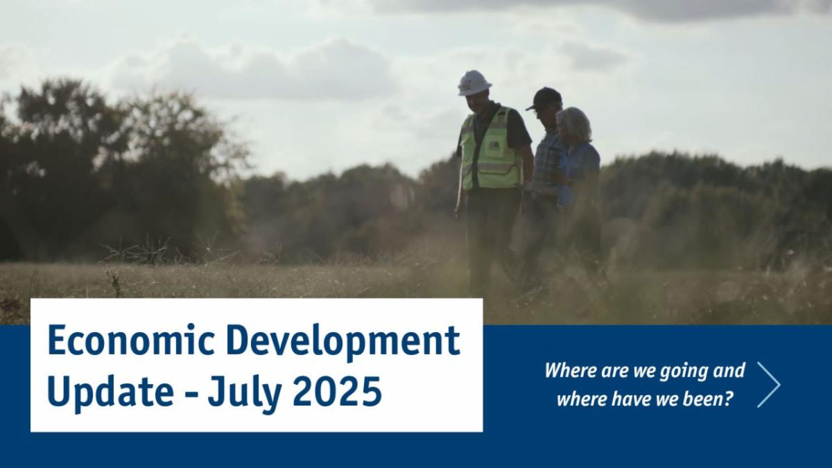 ED Update Graphic with three folks walking in a field that will soon be home to Harnett 95 Industrial Park