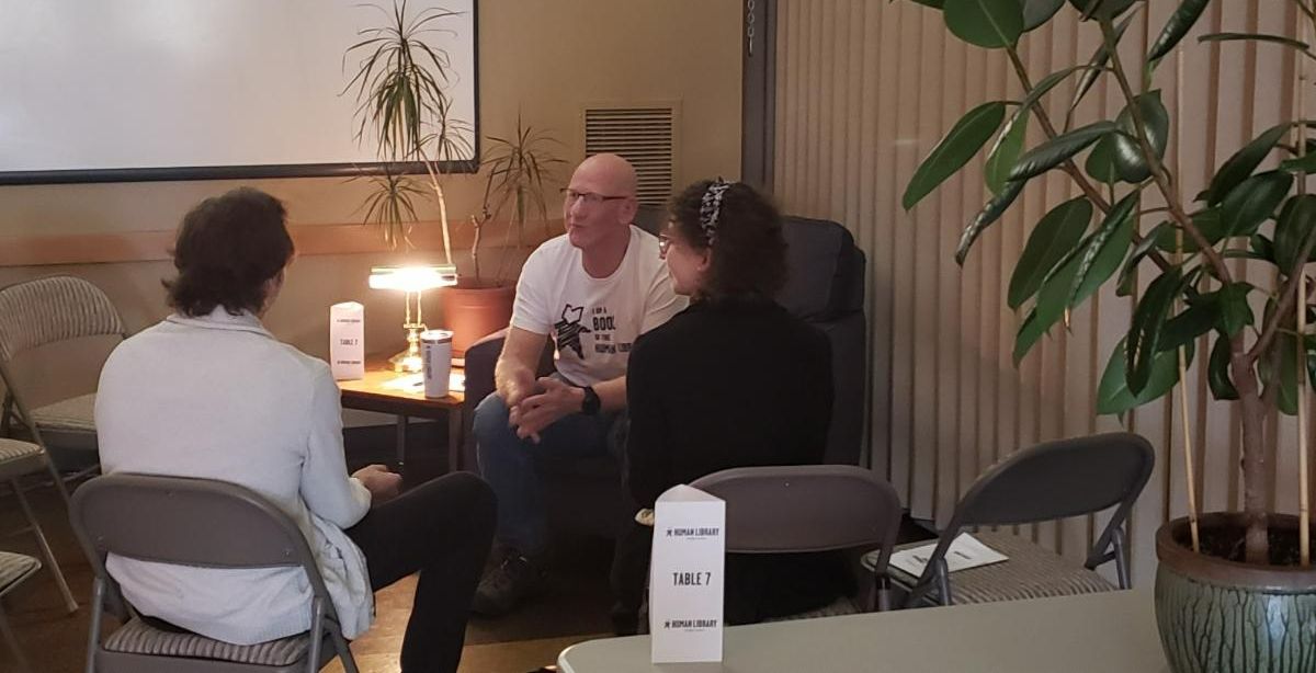 Three people chat at the Human Library event