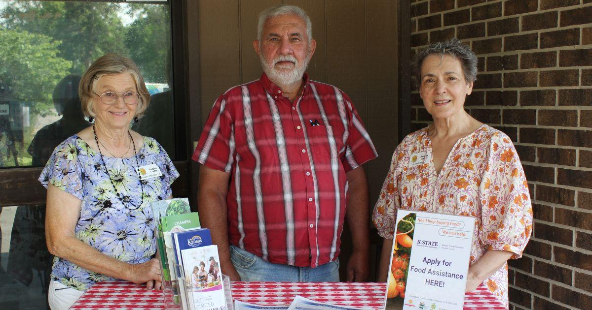 extension master food volunteers in front of their food assistance application help station.