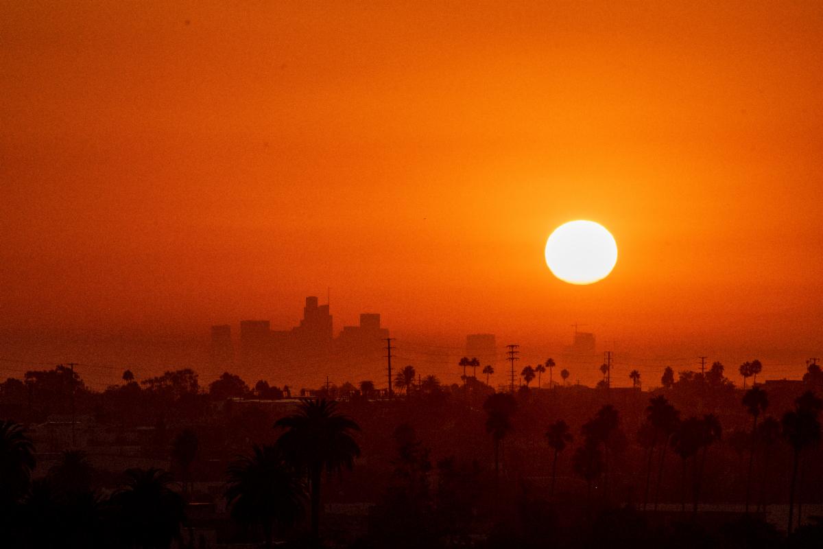 Photo of a city with a bright sun