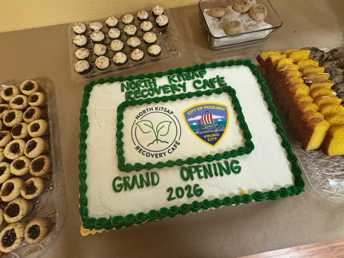 A cake with the Recovery Cafe logo.