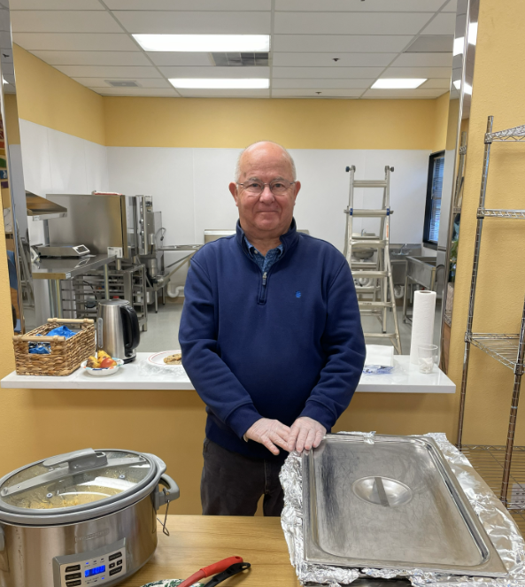 Judge Tolman standing in the Recovery Center Cafe serving meals.