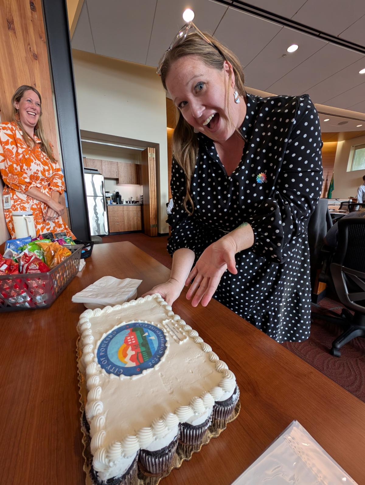 A cake to celebrate the adoption of the Comprehensive Plan by our city council.  Planning Manager Nikole Coleman and Planning and Economic Development Director Heather Wright are presenting the cake.