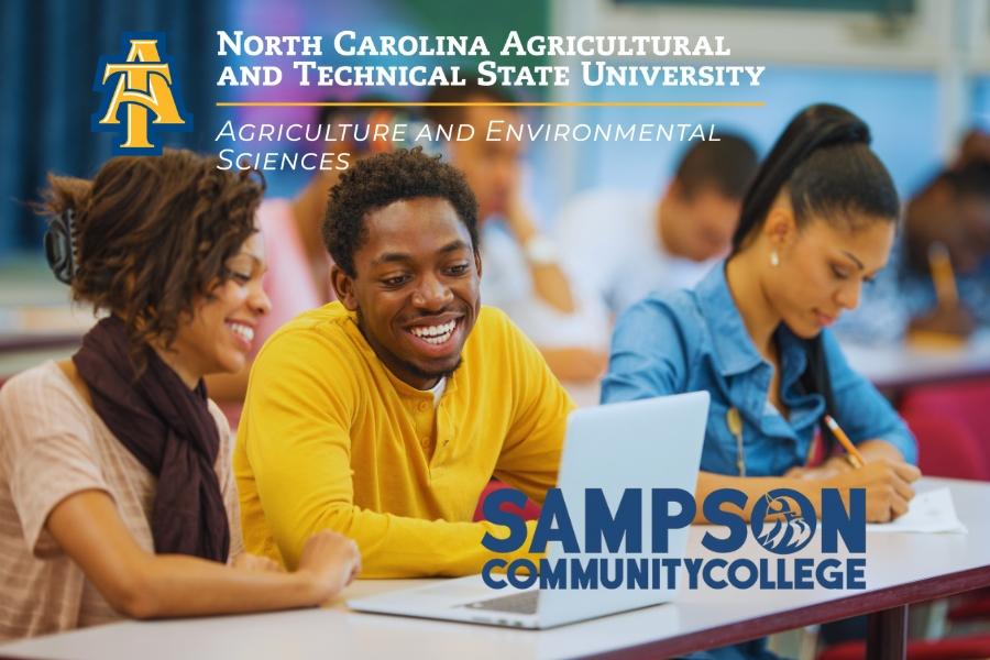 Students sit at laptops and learn together in a classroom. The logos for North Carolina Agricultural and Technical State University and Sampson Community College appear together announcing the joint initiative.