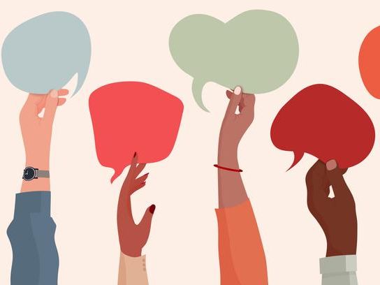 Individuals holding up conversation bubbles