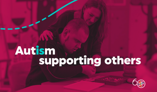 A decorative image with a young man being assisted at a table by a woman the words Autism Is Supporting others on a dark magenta background