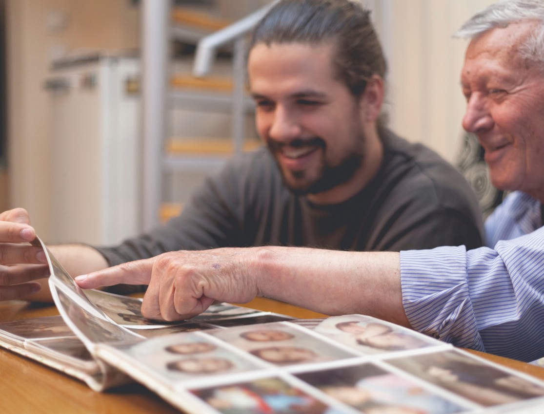 Father and Son looking at Photo album