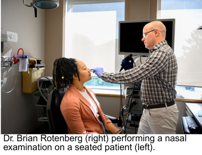 Dr. Brian Rotenberg (right) performing a nasal examination on a seated patient (left).