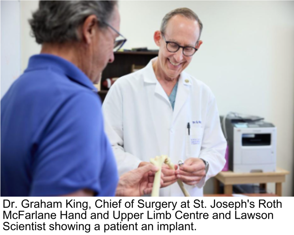 Dr. Graham King Chief of Surgery at St. Joseph's Roth McFarlane Hand and Upper Limb Centre and Lawson Scientist showing a patient an implant.