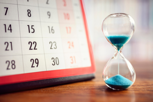 Hour glass and calendar concept for time slipping away for important appointment date_ schedule and deadline