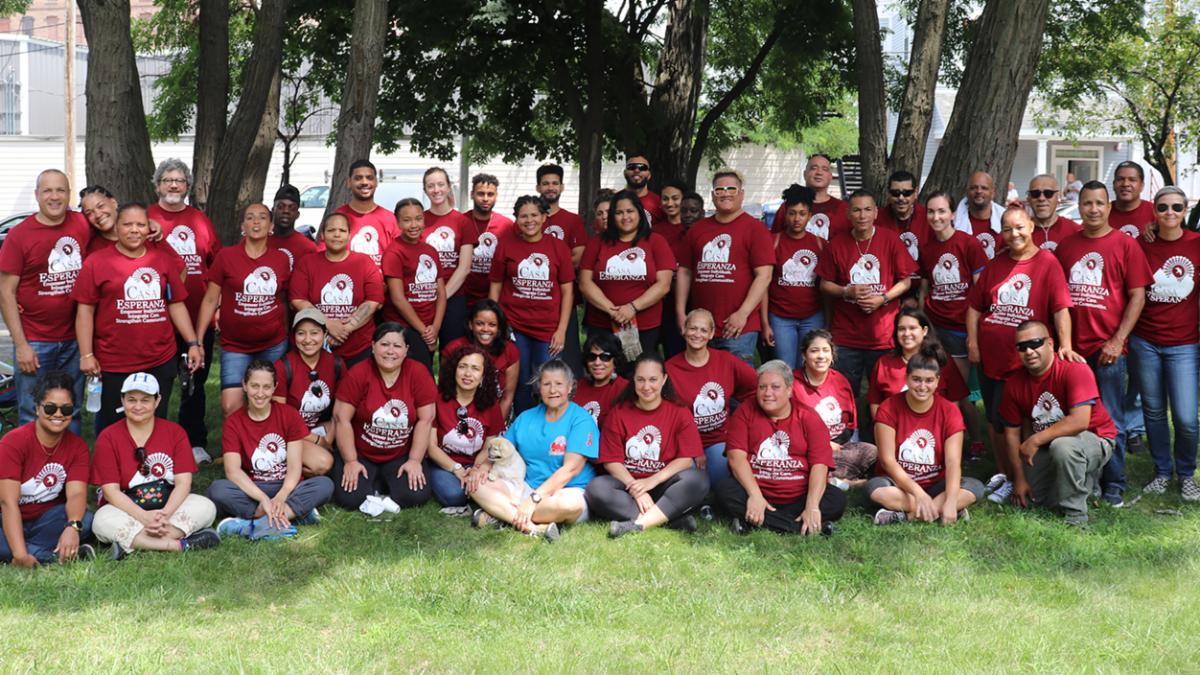 Group Photo of Casa Esperanza Staff outdoors on a grassy lawn in front of some trees