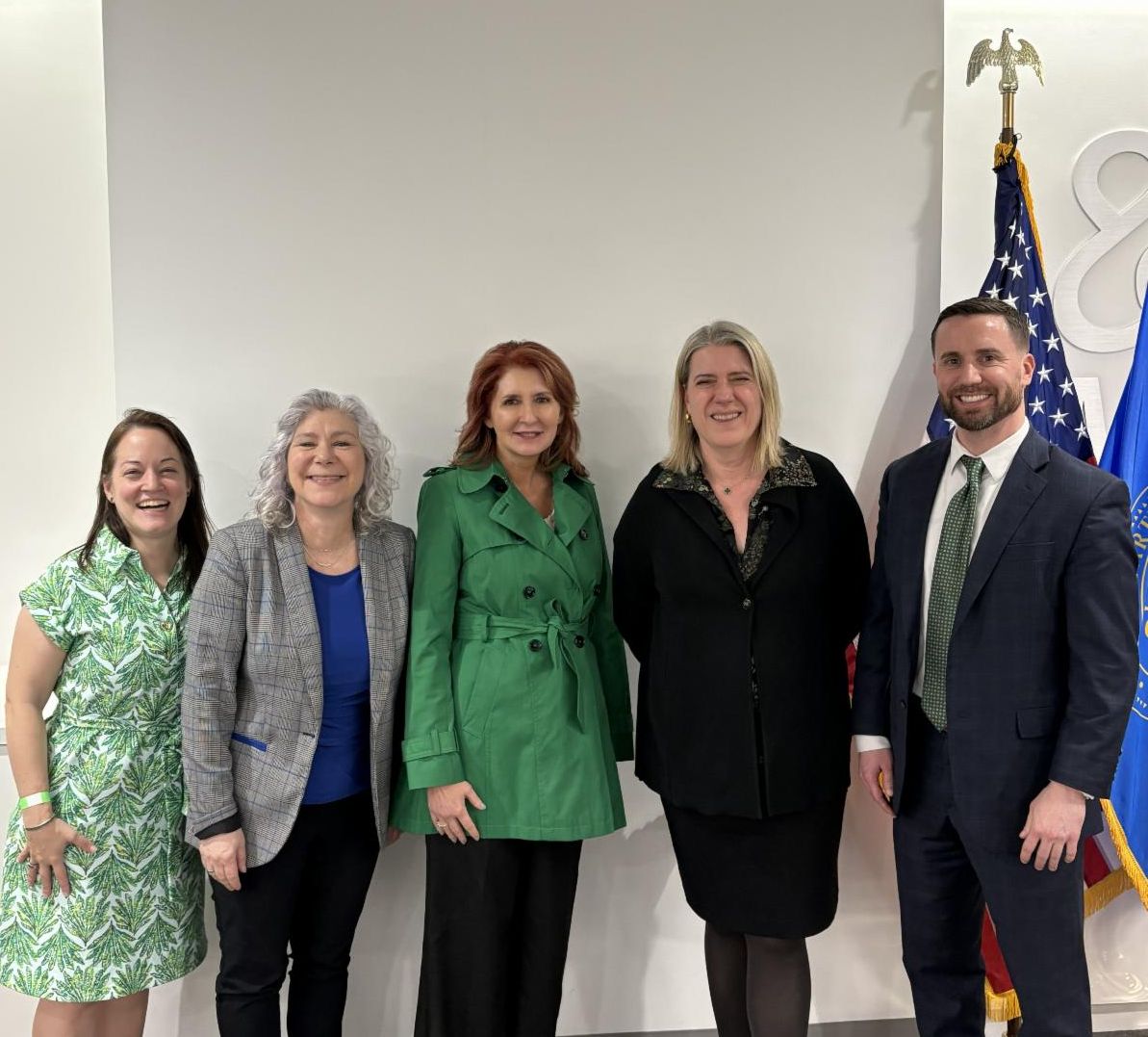 Four white women and a white man pose for a photo together