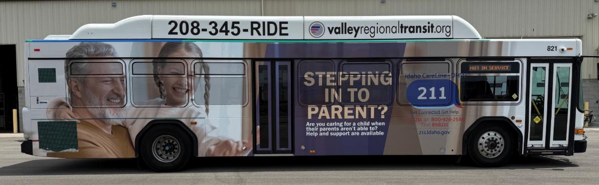Side view of a bus with text that says, "Stepping in to Parent?" as well as the number 211 and an image