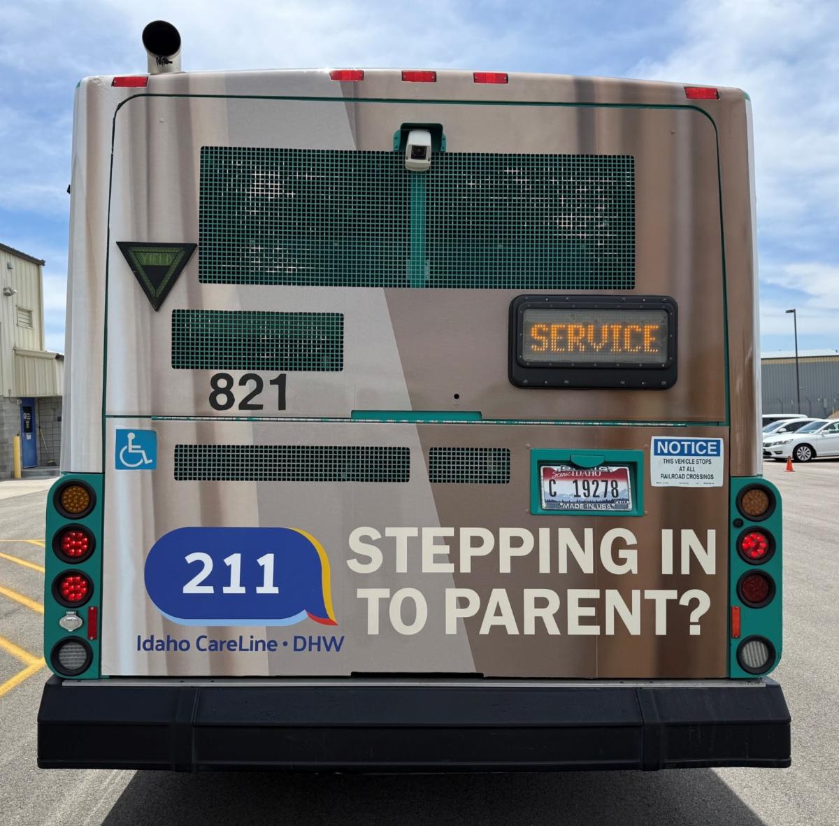 Back view of a bus with text that says, "Stepping in to Parent?" as well as the number 211